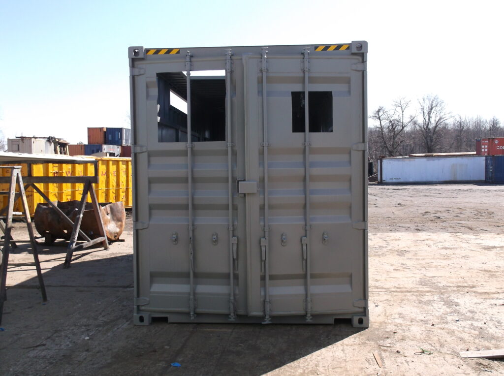 Container with various cut outs and personnel doors installed